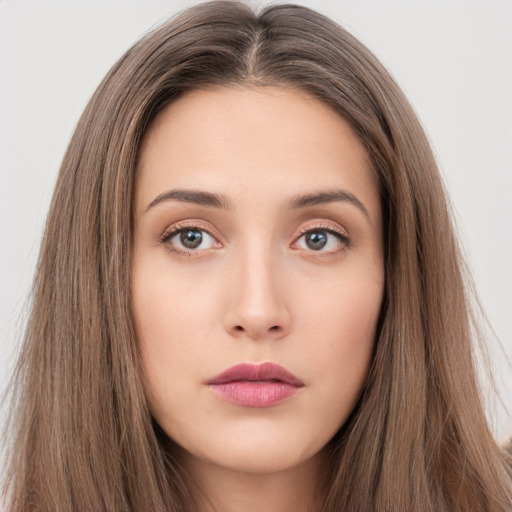 Neutral white young-adult female with long  brown hair and brown eyes