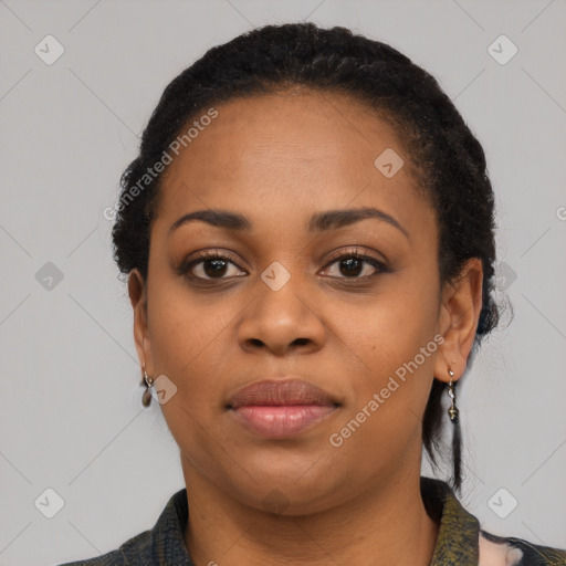 Joyful black young-adult female with short  black hair and brown eyes