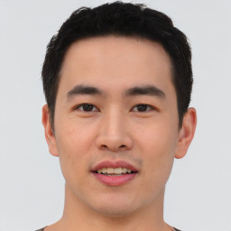 Joyful asian young-adult male with short  black hair and brown eyes