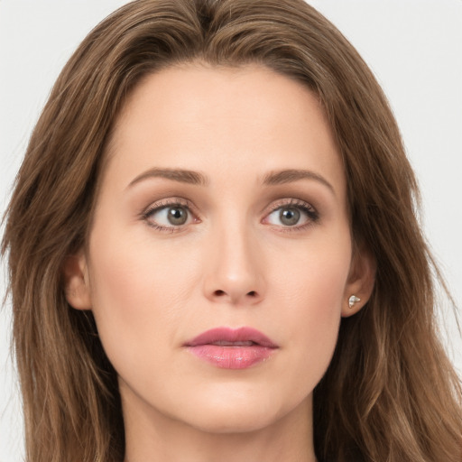 Joyful white young-adult female with long  brown hair and grey eyes