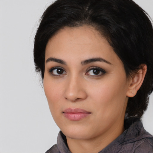 Joyful latino young-adult female with medium  black hair and brown eyes