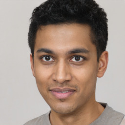 Joyful latino young-adult male with short  black hair and brown eyes