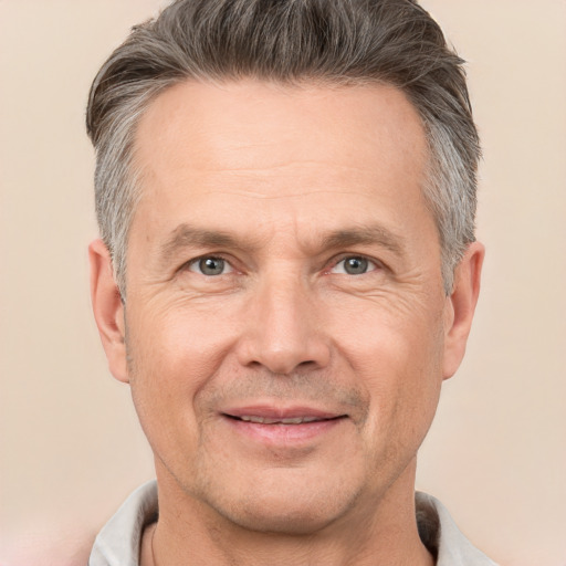 Joyful white adult male with short  gray hair and brown eyes