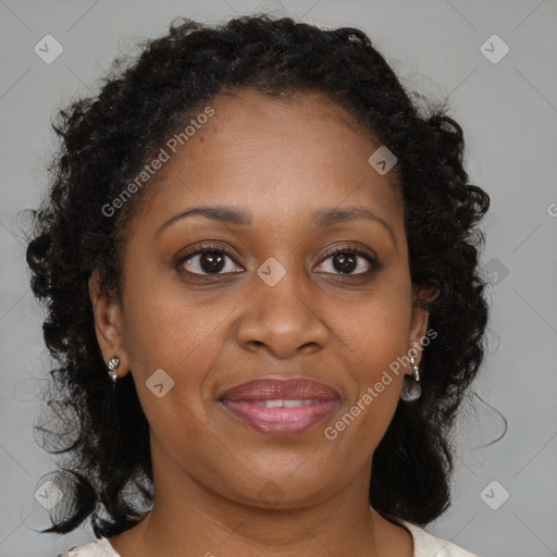 Joyful black adult female with medium  brown hair and brown eyes