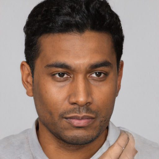 Neutral black young-adult male with short  black hair and brown eyes