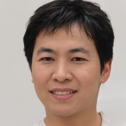 Joyful asian young-adult male with short  brown hair and brown eyes