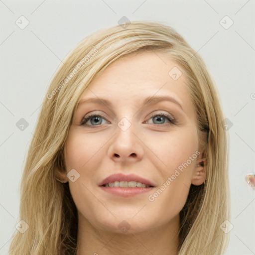 Joyful white young-adult female with long  brown hair and blue eyes