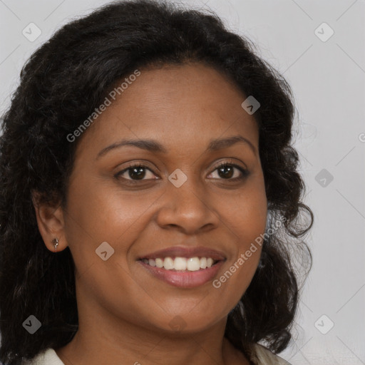 Joyful black young-adult female with long  brown hair and brown eyes