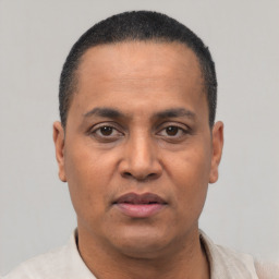 Neutral latino adult male with short  black hair and brown eyes