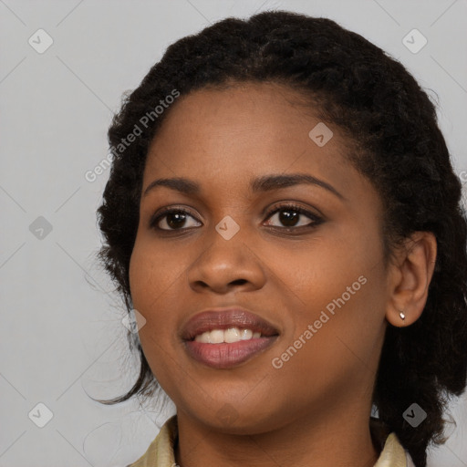 Joyful black young-adult female with long  black hair and brown eyes