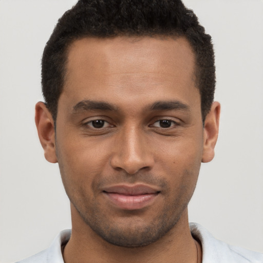 Joyful black young-adult male with short  brown hair and brown eyes