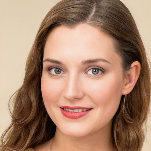 Joyful white young-adult female with long  brown hair and blue eyes