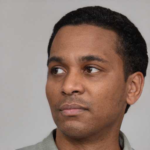Neutral black young-adult male with short  black hair and brown eyes