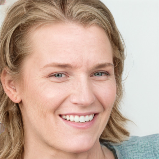 Joyful white young-adult female with medium  brown hair and blue eyes