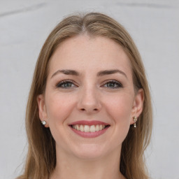 Joyful white young-adult female with long  brown hair and grey eyes