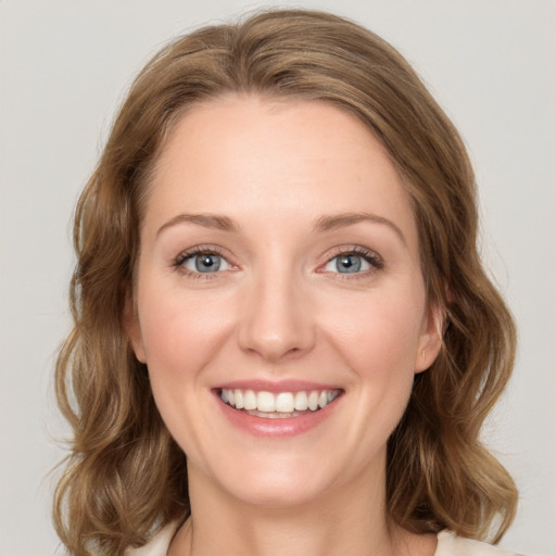 Joyful white young-adult female with medium  brown hair and green eyes