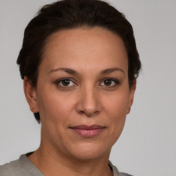 Joyful white adult female with short  brown hair and brown eyes
