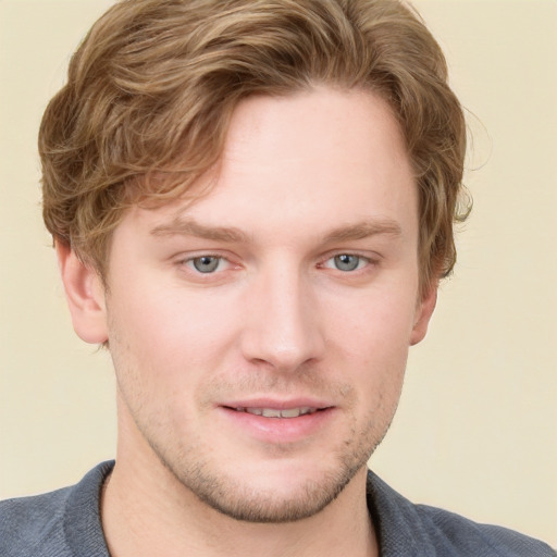 Joyful white young-adult male with short  brown hair and blue eyes