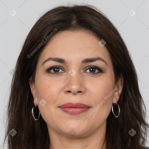 Joyful white adult female with long  brown hair and brown eyes