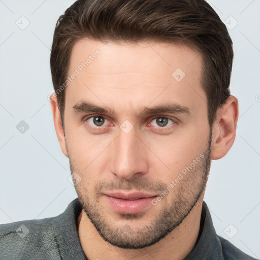 Joyful white young-adult male with short  brown hair and brown eyes