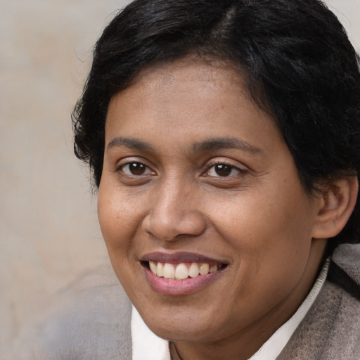 Joyful white adult female with short  brown hair and brown eyes