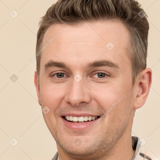 Joyful white young-adult male with short  brown hair and brown eyes