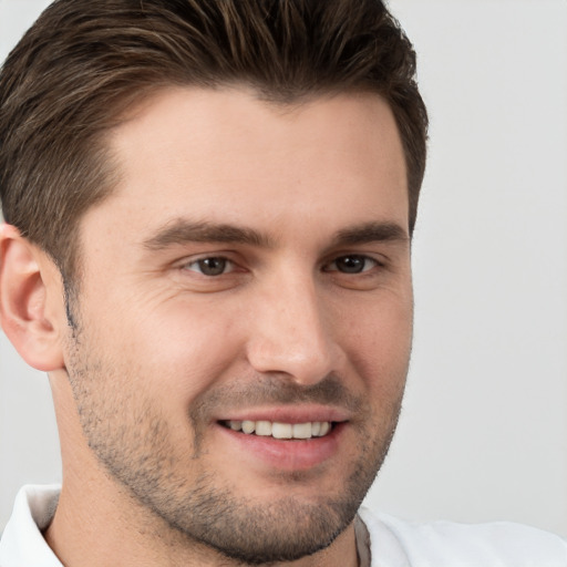 Joyful white young-adult male with short  brown hair and brown eyes