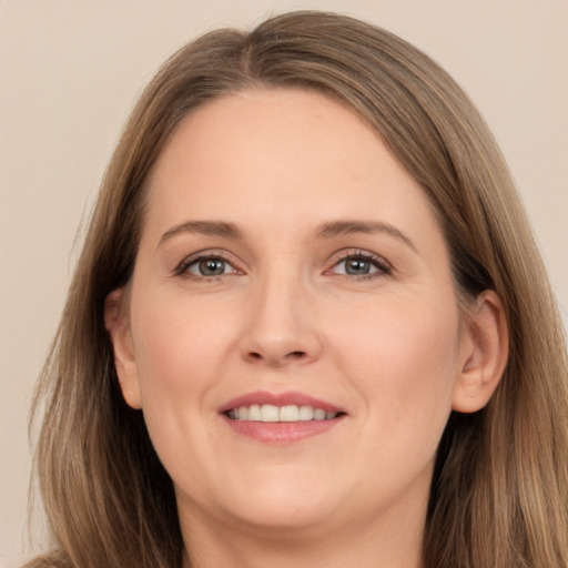 Joyful white adult female with long  brown hair and brown eyes