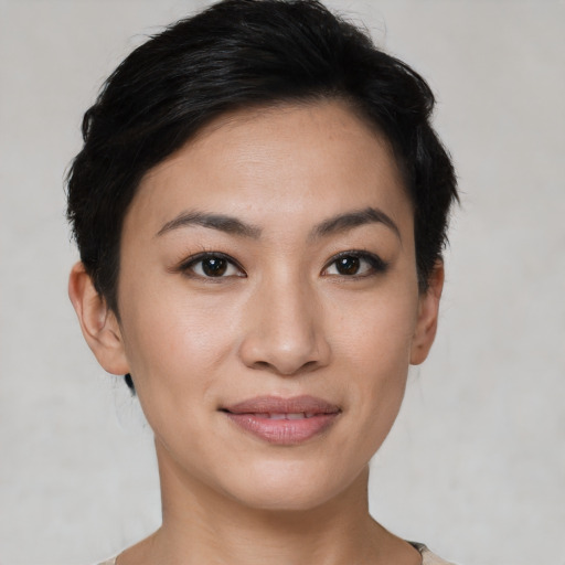 Joyful asian young-adult female with short  black hair and brown eyes