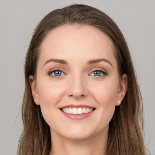 Joyful white young-adult female with long  brown hair and grey eyes