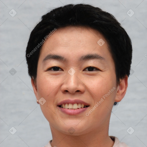 Joyful asian young-adult male with short  black hair and brown eyes