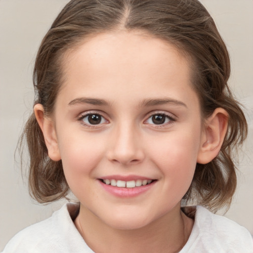 Joyful white child female with medium  brown hair and brown eyes