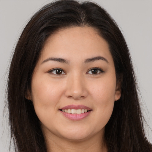 Joyful white young-adult female with long  brown hair and brown eyes
