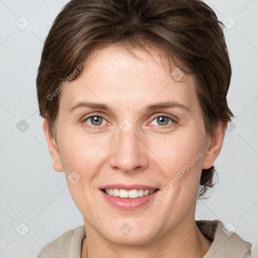 Joyful white young-adult female with short  brown hair and grey eyes