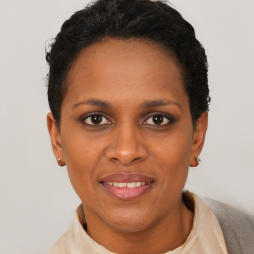 Joyful black young-adult female with short  brown hair and brown eyes