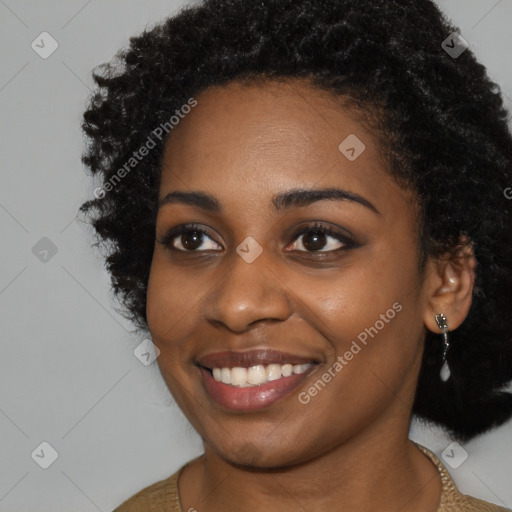 Joyful black young-adult female with long  black hair and brown eyes