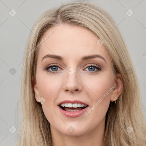 Joyful white young-adult female with long  brown hair and blue eyes