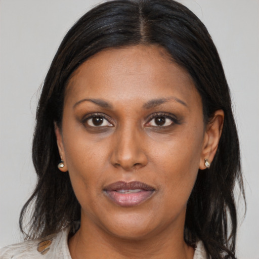 Joyful black adult female with medium  brown hair and brown eyes