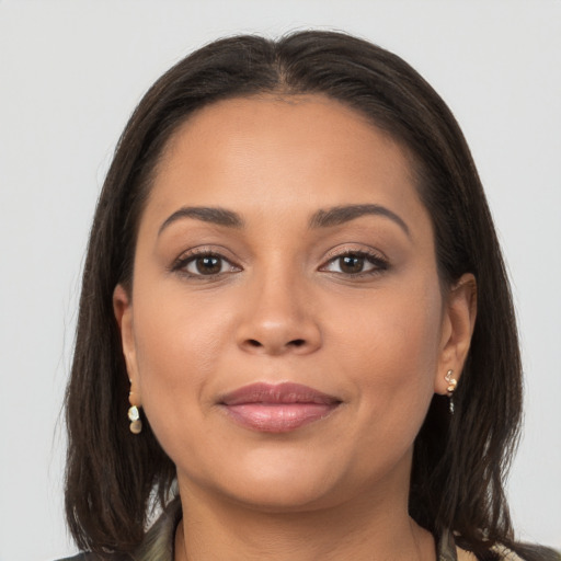 Joyful latino young-adult female with long  brown hair and brown eyes