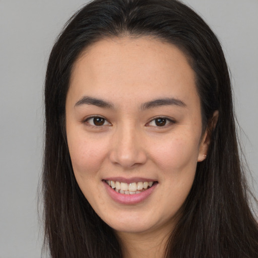 Joyful white young-adult female with long  brown hair and brown eyes