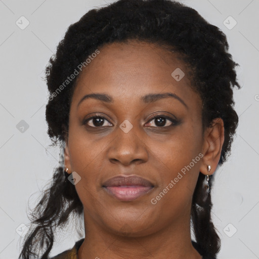 Joyful black young-adult female with long  black hair and brown eyes