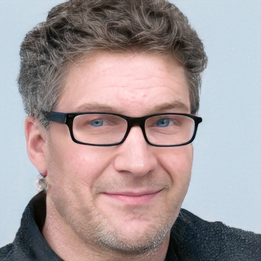 Joyful white adult male with short  brown hair and blue eyes