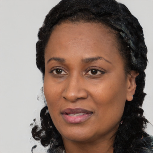 Joyful black adult female with medium  black hair and brown eyes