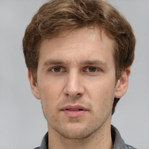 Joyful white adult male with short  brown hair and grey eyes