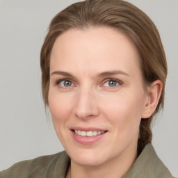 Joyful white adult female with medium  brown hair and grey eyes