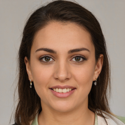 Joyful white young-adult female with long  brown hair and brown eyes