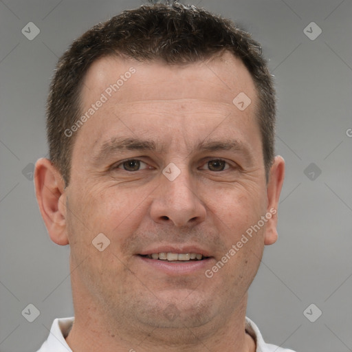 Joyful white adult male with short  brown hair and brown eyes