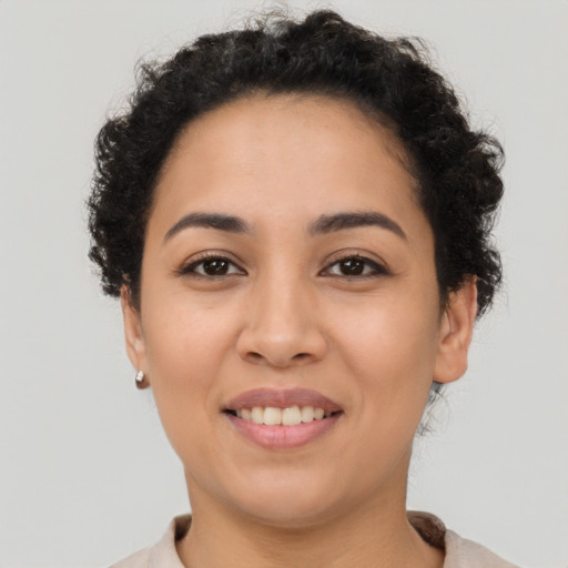 Joyful latino young-adult female with short  brown hair and brown eyes
