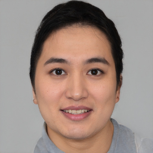 Joyful white young-adult female with short  brown hair and brown eyes