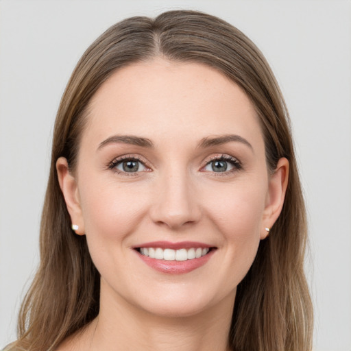 Joyful white young-adult female with long  brown hair and grey eyes